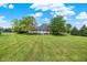 Beautiful home with a large, meticulously manicured lawn, perfect for outdoor activities and relaxation at 11250 N 600 W, Fountaintown, IN 46130