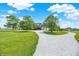 Long driveway leads to a beautiful home with mature trees, landscaping, and a large lawn at 11250 N 600 W, Fountaintown, IN 46130