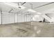 Spacious three-car garage with ample storage, multiple garage doors, and bright lighting at 11250 N 600 W, Fountaintown, IN 46130