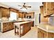 Well-lit kitchen featuring an island, wood cabinetry, tile floors, and modern appliances at 11250 N 600 W, Fountaintown, IN 46130