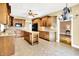 Spacious kitchen with a center island, tile floor, wooden cabinets, and modern appliances at 11250 N 600 W, Fountaintown, IN 46130