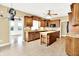 Charming kitchen with wooden cabinets, island, and a view into the sun room at 11250 N 600 W, Fountaintown, IN 46130
