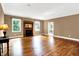 Comfortable living room with hardwood floors, a fireplace, and large windows offering scenic views at 11250 N 600 W, Fountaintown, IN 46130