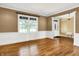 Bright living room featuring hardwood floors, large window, and elegant trim work, adjacent to the entryway at 11250 N 600 W, Fountaintown, IN 46130
