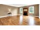 Inviting living room with hardwood floors, a cozy fireplace, and ample natural light from well-placed windows at 11250 N 600 W, Fountaintown, IN 46130