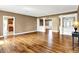 Open-concept living space with hardwood floors, decorative columns, and natural light, connecting to kitchen at 11250 N 600 W, Fountaintown, IN 46130