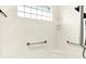 Modern shower with glass block window, grab bars and built-in shelving at 11250 N 600 W, Fountaintown, IN 46130