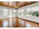 Bright sunroom with wood floors, ceiling fan, white walls, and many windows at 11250 N 600 W, Fountaintown, IN 46130