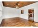 Open-concept living space featuring wood floors and a view into the kitchen at 11250 N 600 W, Fountaintown, IN 46130