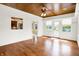 Inviting sunroom featuring wood floors, shiplap walls, and access to the kitchen at 11250 N 600 W, Fountaintown, IN 46130