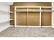 Generous walk-in closet boasting neutral carpet, white shelving, and wood railing for hanging and organizing clothes at 11250 N 600 W, Fountaintown, IN 46130
