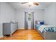 Bedroom with wood floors, light gray paint and ceiling fan at 11424 Green St, Carmel, IN 46033