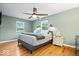 Bedroom featuring wood floors, a ceiling fan, and bright natural light at 11424 Green St, Carmel, IN 46033