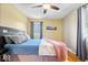 Cozy bedroom with hardwood floors, ceiling fan, and natural light at 11424 Green St, Carmel, IN 46033