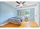 Bedroom with hardwood floors, ceiling fan, and plenty of sunlight at 11424 Green St, Carmel, IN 46033