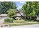 Charming two-story home with attached garage, landscaped yard, and mature trees at 11424 Green St, Carmel, IN 46033
