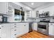Well-appointed kitchen with white cabinets, stainless steel appliances, and modern fixtures at 11424 Green St, Carmel, IN 46033