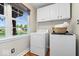 Laundry room featuring a window, washer, dryer, and cabinetry at 11424 Green St, Carmel, IN 46033