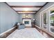 Cozy living room with hardwood floors, fireplace, french doors to patio, and gray walls at 11424 Green St, Carmel, IN 46033