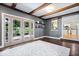 Open-concept living room features hardwood floors, french doors, and an entrance to the kitchen at 11424 Green St, Carmel, IN 46033