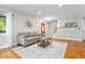 Bright living room features hardwood floors and staircase at 11424 Green St, Carmel, IN 46033