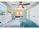 Relaxing main bedroom boasts soft green walls, a ceiling fan, and closet space at 11424 Green St, Carmel, IN 46033