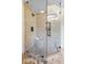 Modern bathroom shower with glass door and tiled walls with bench seat at 11424 Green St, Carmel, IN 46033
