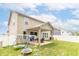 Lush backyard featuring a covered patio, green lawn, and play area, perfect for Gathering enjoyment at 1156 Brockton Ct, Greenfield, IN 46140
