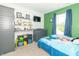 Bright bedroom with a bed, shelves, and green walls at 1156 Brockton Ct, Greenfield, IN 46140