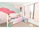 Colorful bedroom features a bed, stuffed animals, and a window at 1156 Brockton Ct, Greenfield, IN 46140
