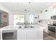 Bright and airy kitchen featuring white cabinetry, an island with seating, and modern appliances at 1156 Brockton Ct, Greenfield, IN 46140