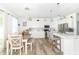 Contemporary kitchen with white cabinets, subway tile backsplash, and a dining area at 1156 Brockton Ct, Greenfield, IN 46140