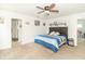 Bright main bedroom with a ceiling fan, carpet floors, and an ensuite bathroom and walk-in closet at 1156 Brockton Ct, Greenfield, IN 46140