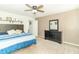Bright main bedroom features carpet floors, neutral walls, ceiling fan, and a large dresser with a mirror at 1156 Brockton Ct, Greenfield, IN 46140