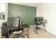 Spacious office featuring green accent wall, modern desk setup, and comfortable work environment at 1156 Brockton Ct, Greenfield, IN 46140