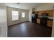 Eat-in kitchen with modern flooring, wooden cabinets, and black appliances at 11726 Pawleys Ct, Indianapolis, IN 46235