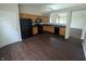 Kitchen with modern flooring, wooden cabinets, and black appliances at 11726 Pawleys Ct, Indianapolis, IN 46235
