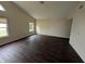 Bright living room featuring modern flooring, neutral walls, and large windows at 11726 Pawleys Ct, Indianapolis, IN 46235