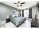 Main bedroom with luxury vinyl flooring, ceiling fan, and a gray accent wall at 1187 Blackthorne S Trl, Plainfield, IN 46168