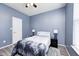 Comfortable bedroom with a ceiling fan, a window, a bed with lamps, and wood grain floors at 1187 Blackthorne S Trl, Plainfield, IN 46168