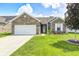 Charming single-story home with a brick facade, well-manicured lawn, and attached two car garage at 1187 Blackthorne S Trl, Plainfield, IN 46168