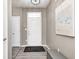 View of foyer with adjacent doors, bench, art, light gray walls and wood-look flooring at 1187 Blackthorne S Trl, Plainfield, IN 46168