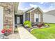 Close-up of charming front door with decorative wreath, beautiful landscaping and a well-lit walkway at 1187 Blackthorne S Trl, Plainfield, IN 46168
