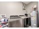 A laundry room with gray washer and dryer, and a hot water tank at 1187 Blackthorne S Trl, Plainfield, IN 46168