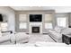 Inviting living room with a fireplace, recessed lighting, and large windows providing ample natural light at 1187 Blackthorne S Trl, Plainfield, IN 46168