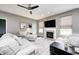 Comfortable living room featuring a fireplace, ceiling fan, and a neutral color palette at 1187 Blackthorne S Trl, Plainfield, IN 46168