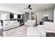 Spacious living room featuring neutral decor, ceiling fan, hardwood floors, and open-concept layout at 1187 Blackthorne S Trl, Plainfield, IN 46168