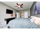 This main bedroom offers luxury vinyl flooring, ceiling fan, and a tv at 1187 Blackthorne S Trl, Plainfield, IN 46168