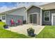Back patio with a stone divider and wrought iron chairs, perfect for entertaining at 1187 Blackthorne S Trl, Plainfield, IN 46168