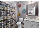 Bathroom with a colorful shower curtain, a white vanity, and decorative floral art on the wall at 1201 Fantail Dr, Greenwood, IN 46143
